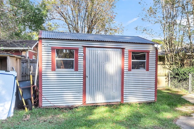 view of outbuilding with a yard