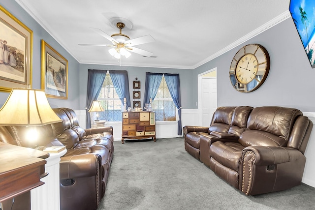 carpeted living room with ceiling fan and crown molding