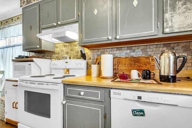 kitchen featuring gray cabinets, white appliances, and decorative backsplash