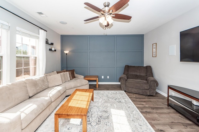 living room with ceiling fan and wood-type flooring