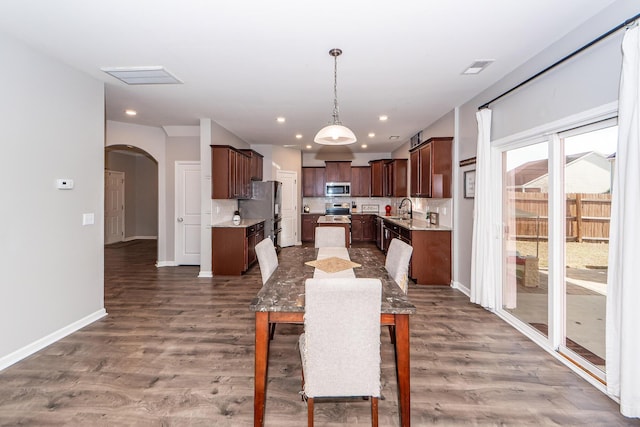 dining room with dark hardwood / wood-style floors and sink