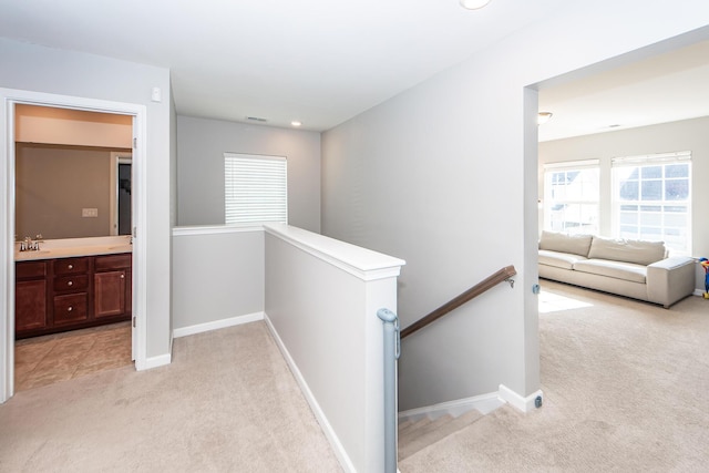 hallway with light colored carpet