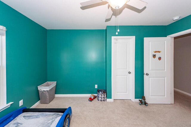 carpeted bedroom with ceiling fan