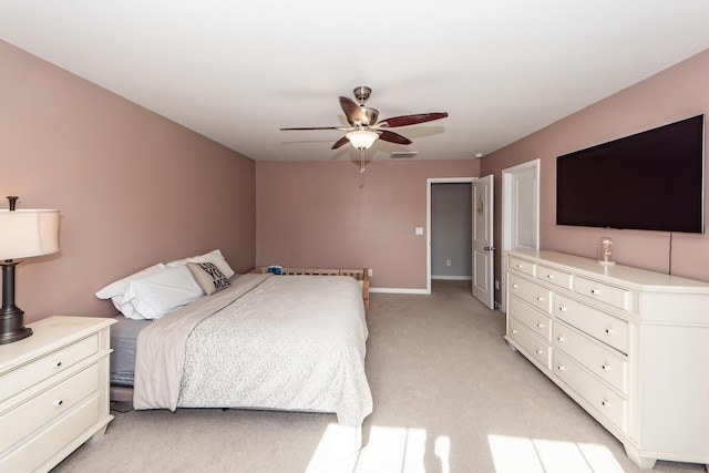 bedroom with ceiling fan and light colored carpet