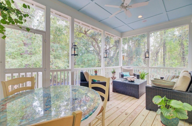 sunroom with ceiling fan and a drop ceiling