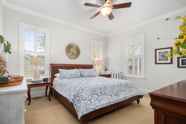 carpeted bedroom featuring ceiling fan and crown molding