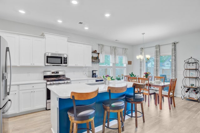 135 Cypress Preserve Blvd, Moncks Corner, SC 29461 - kitchen with stainless steel appliances, a sink, a chandelier, a kitchen island with sink, and light countertops