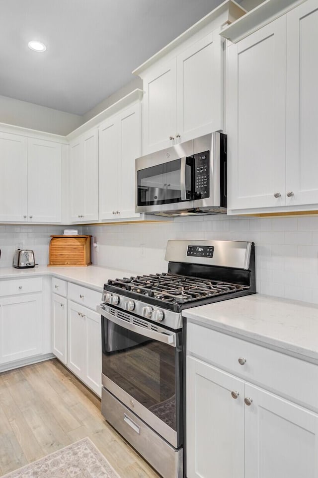 135 Cypress Preserve Blvd, Moncks Corner, SC 29461 - kitchen featuring appliances with stainless steel finishes, decorative backsplash, white cabinets, and recessed lighting