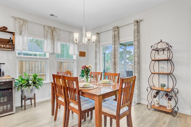 135 Cypress Preserve Blvd, Moncks Corner, SC 29461 - dining room with light wood-style flooring, wine cooler, a chandelier, and baseboards