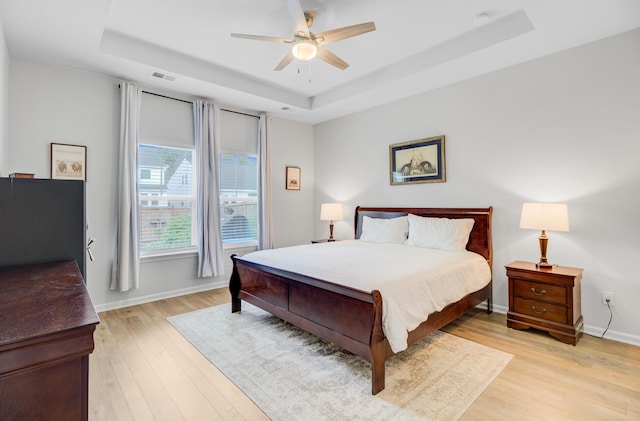 135 Cypress Preserve Blvd, Moncks Corner, SC 29461 - bedroom featuring a tray ceiling, light wood-style floors, baseboards, and a ceiling fan