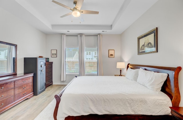 135 Cypress Preserve Blvd, Moncks Corner, SC 29461 - bedroom featuring a raised ceiling, light wood-style floors, multiple windows, and ceiling fan