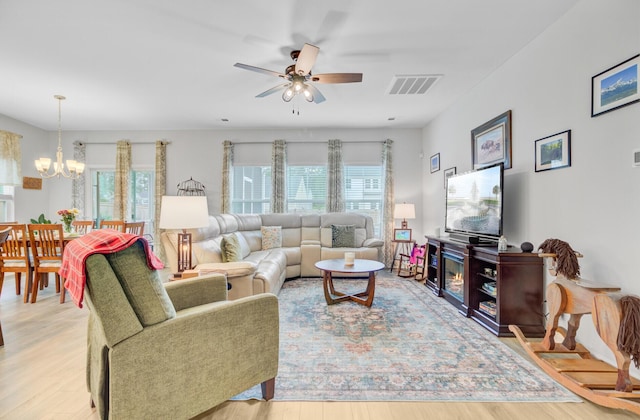 135 Cypress Preserve Blvd, Moncks Corner, SC 29461 - living area featuring healthy amount of natural light, ceiling fan, wood finished floors, and a chandelier