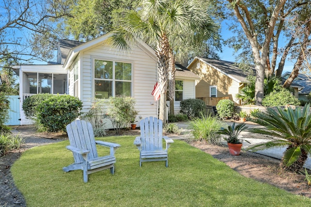 exterior space with a sunroom and a yard