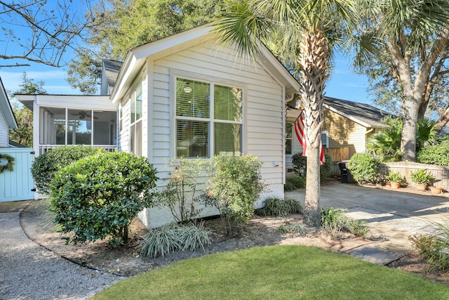 view of property exterior featuring a sunroom