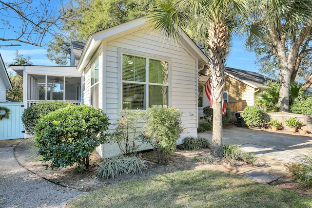 view of home's exterior with a sunroom