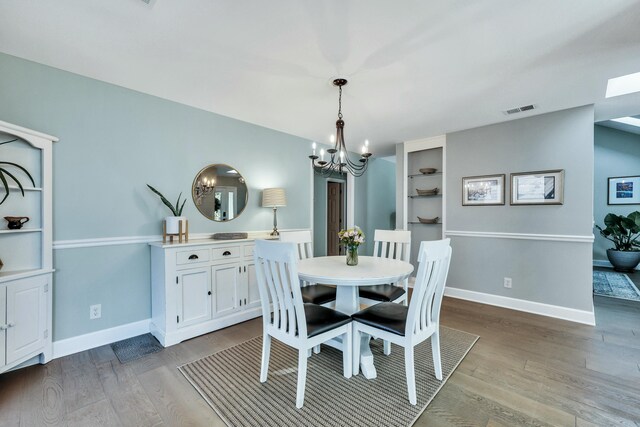 dining room featuring an inviting chandelier and light hardwood / wood-style flooring