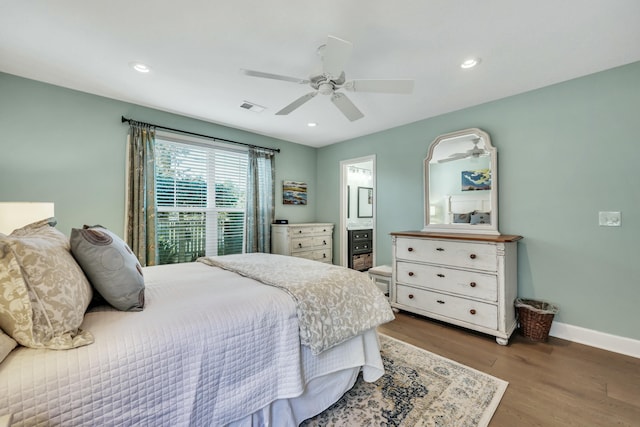 bedroom featuring ceiling fan, ensuite bathroom, and hardwood / wood-style flooring