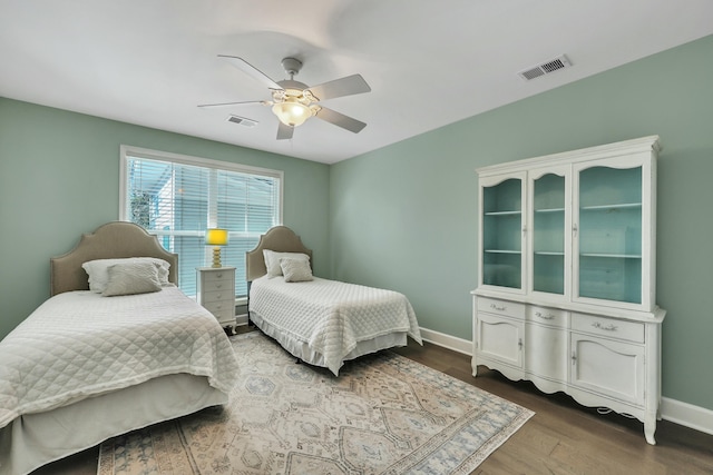 bedroom with wood-type flooring and ceiling fan