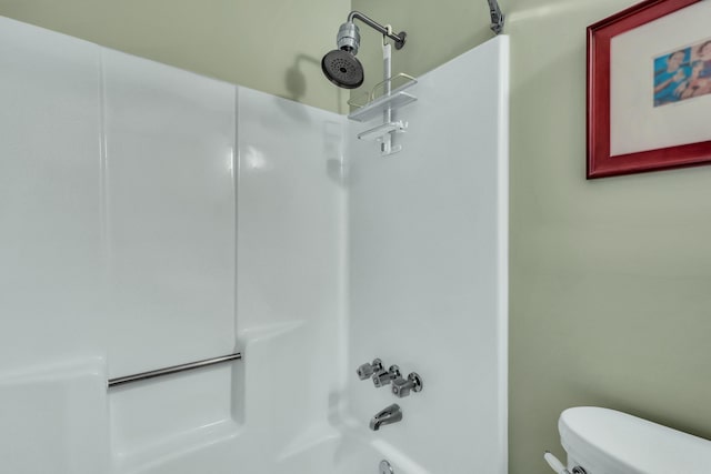 bathroom with toilet and bathtub / shower combination