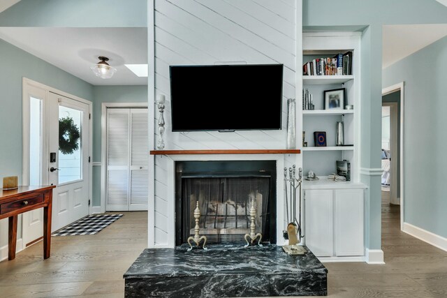 living room featuring hardwood / wood-style floors and built in shelves