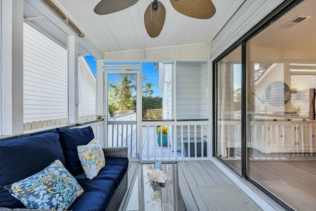 sunroom / solarium featuring ceiling fan, a healthy amount of sunlight, vaulted ceiling, and wooden ceiling