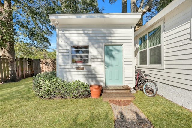 doorway to property featuring a yard