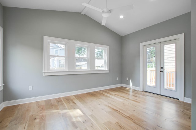 unfurnished room featuring light wood-type flooring, a wealth of natural light, vaulted ceiling with beams, and baseboards