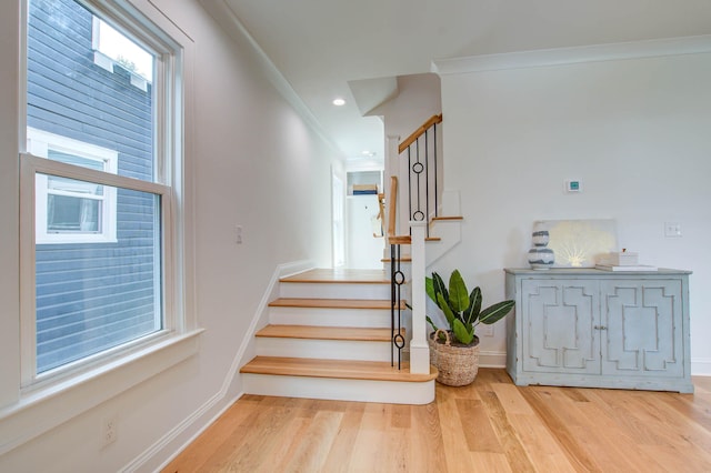 stairs featuring ornamental molding, recessed lighting, wood finished floors, and baseboards