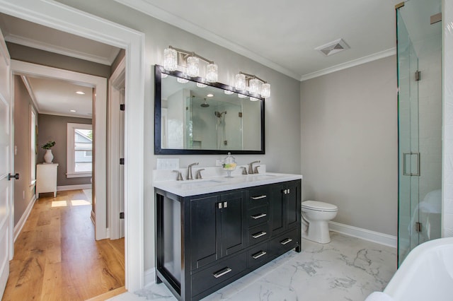 full bathroom with a sink, a shower stall, baseboards, and crown molding