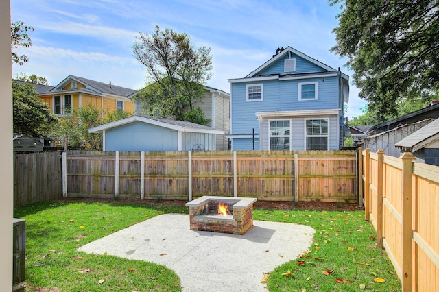 view of yard with an outdoor fire pit, a patio area, and a fenced backyard