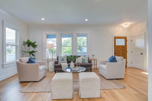 living room featuring recessed lighting, baseboards, crown molding, and light wood finished floors