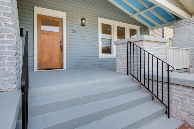 doorway to property with brick siding