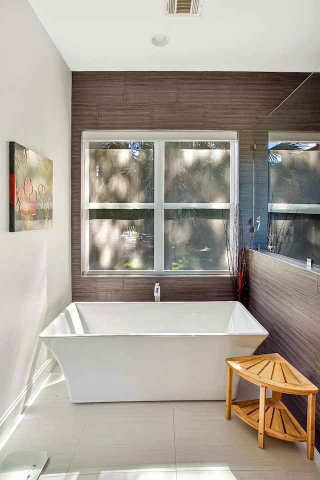 bathroom featuring a bathtub and tile patterned flooring