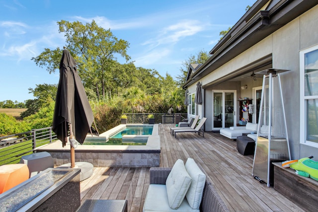 wooden deck with an outdoor hangout area, ceiling fan, and a fenced in pool