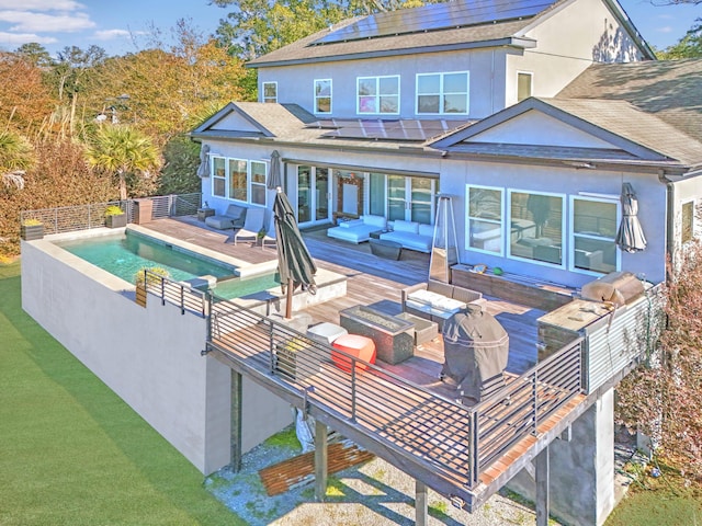 back of property with an outdoor hangout area, solar panels, a pool side deck, and a lawn