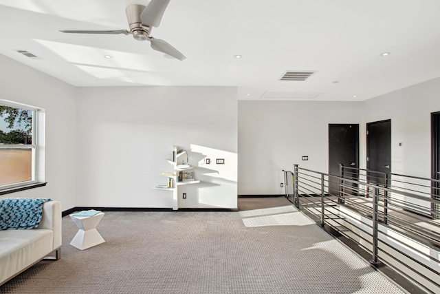 living area featuring ceiling fan and carpet flooring