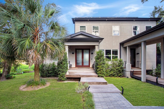 exterior space with french doors and a front yard