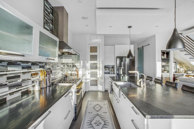 kitchen featuring white cabinets, pendant lighting, and stainless steel appliances