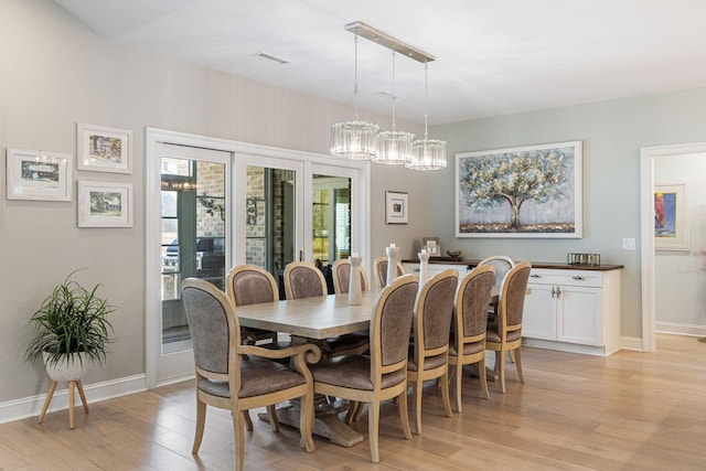 dining space with light hardwood / wood-style floors