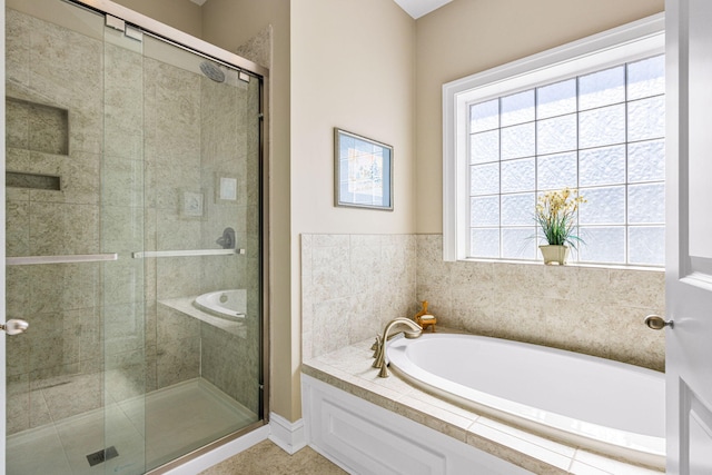 bathroom featuring plus walk in shower and plenty of natural light