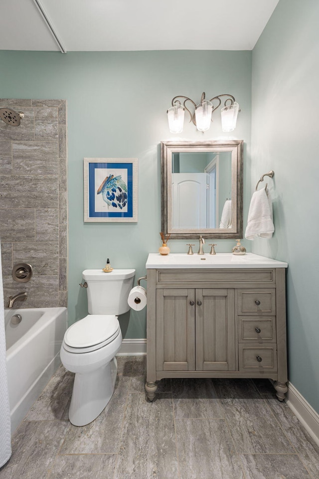 full bathroom featuring vanity, tiled shower / bath combo, hardwood / wood-style flooring, and toilet