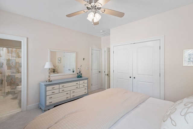 bedroom with ensuite bath, light carpet, and ceiling fan