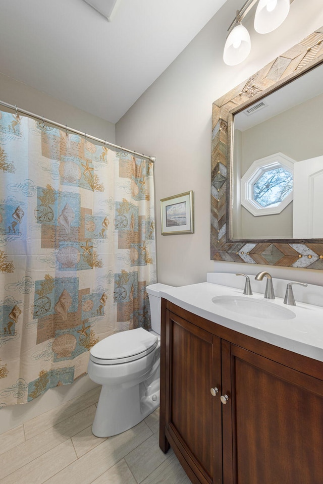 bathroom with tile patterned floors, vanity, and toilet