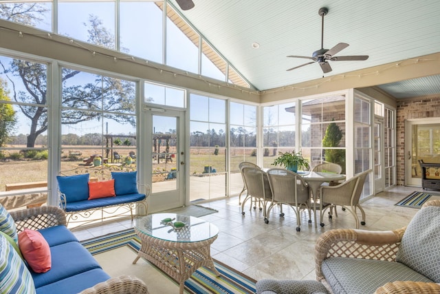 sunroom featuring vaulted ceiling, plenty of natural light, and ceiling fan