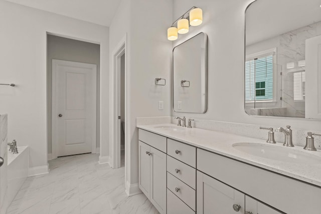 bathroom featuring a sink, double vanity, baseboards, and marble finish floor