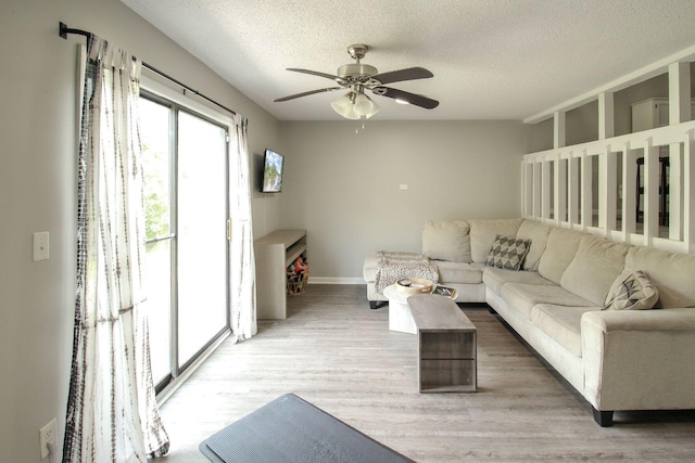 104 Queens Ct, Summerville, SC 29485 - living room with a ceiling fan, light wood-style flooring, and a textured ceiling