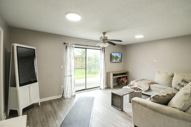 104 Queens Ct, Summerville, SC 29485 - living area with a textured ceiling, light wood-type flooring, and a ceiling fan