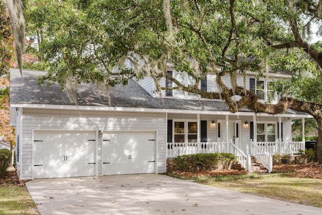 view of front of home with a porch and a garage