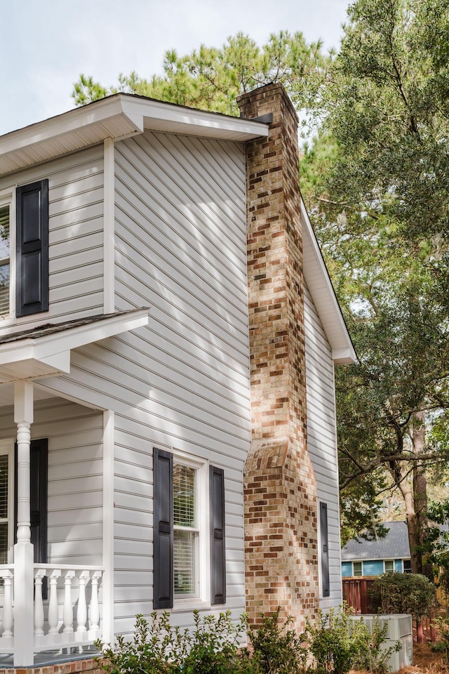 view of property exterior featuring covered porch