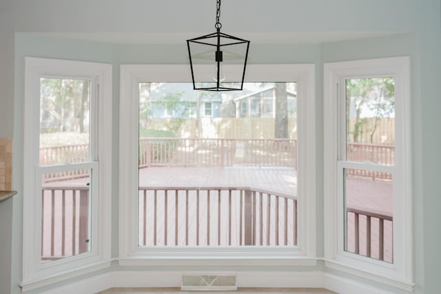 unfurnished sunroom featuring an inviting chandelier